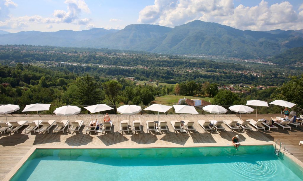 Event location with big pool and view. Deck chairs and umbrellas.