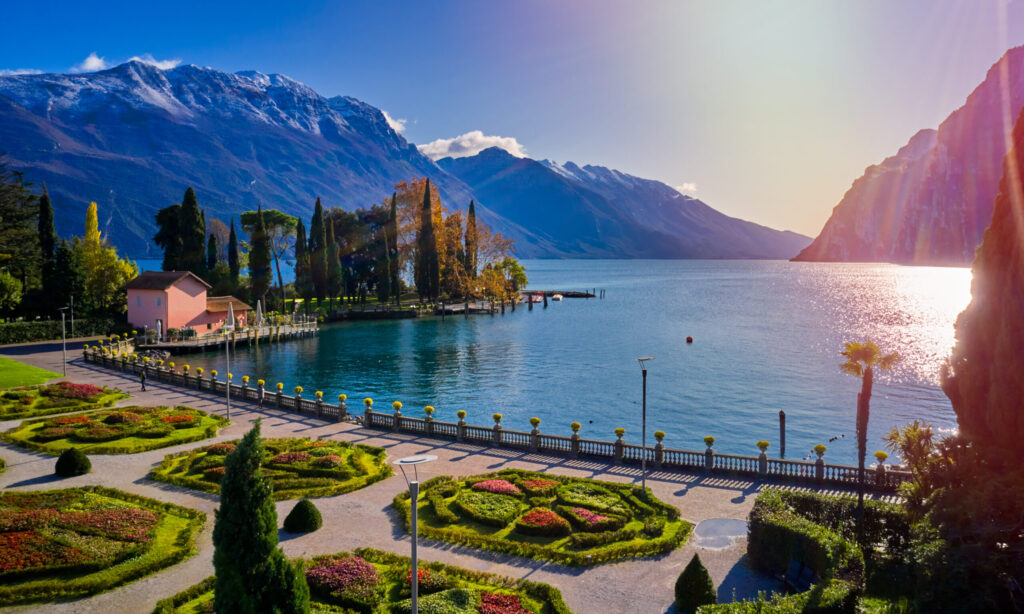 Panorama of the gorgeous Garda lake surrounded by mountains in the autumn time