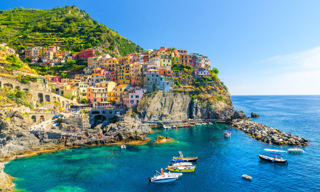 Little boats in front of the colorful village Manarola in the famous Cinque Terre on the Ligurian Riviera