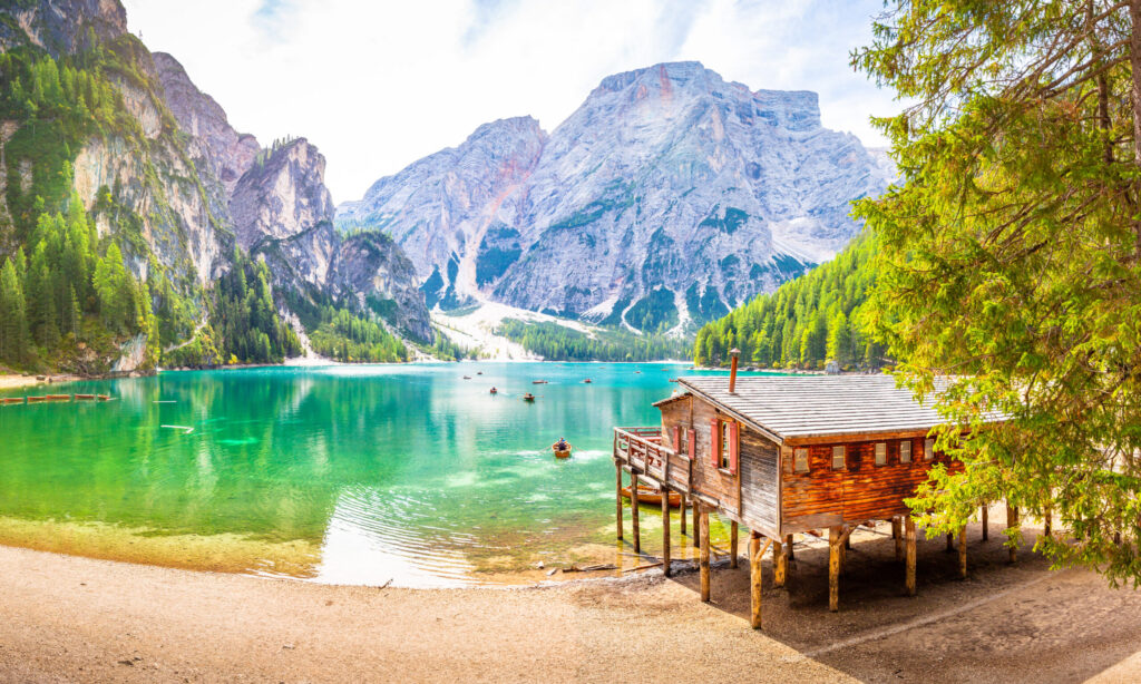 Jetty with little boats at Lago di Braies lake in the Dolomites