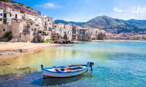 Old harbor with wooden fishing boat in Cefalù, Sicily