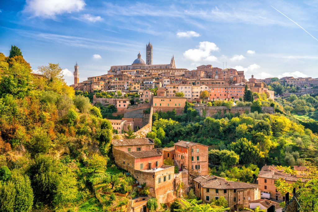 Downtown Siena skyline in Italy with blue sky