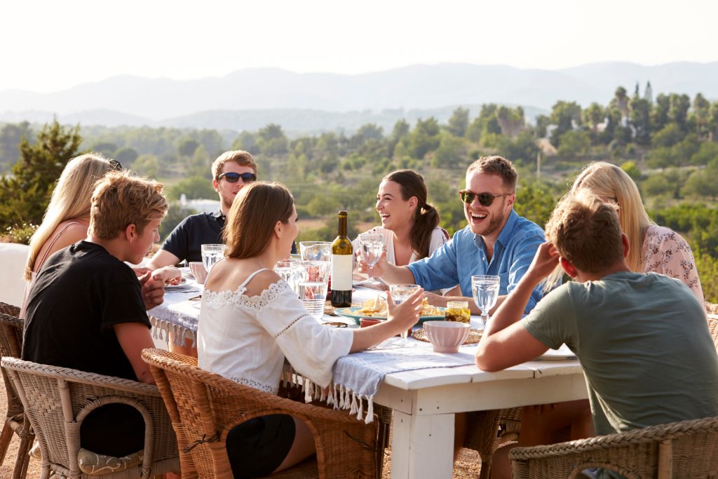 Group Of Young Friends Enjoying Outdoor Meal On Holiday