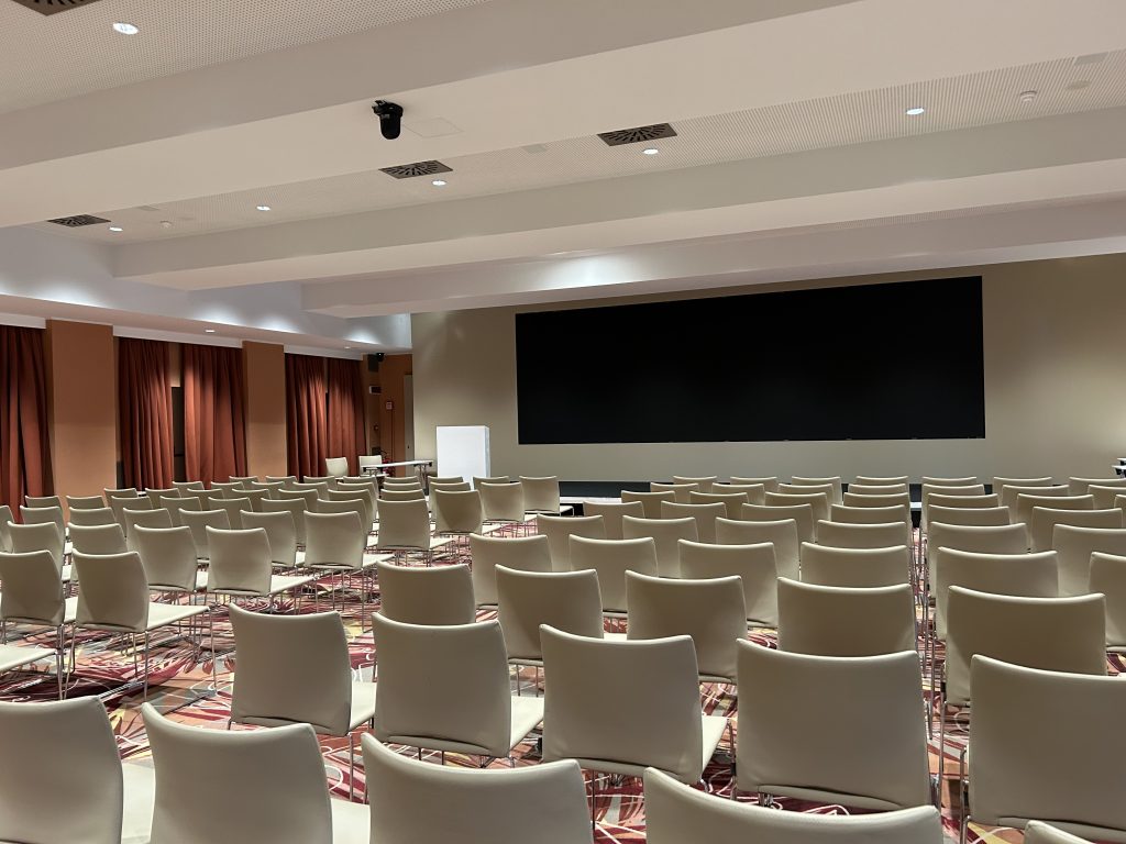 Conference room with chairs and screen.