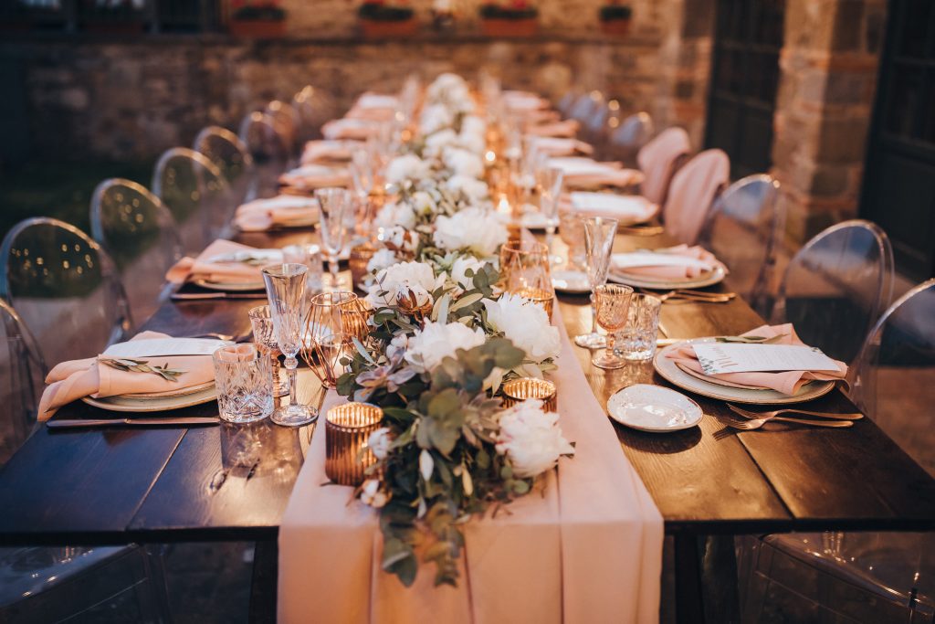 Wooden wedding table in villa with flowers and decoration.