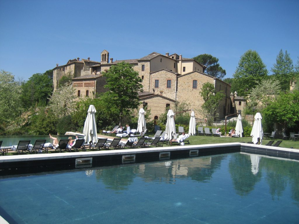 Big pool and sun chairs, castle in Italy.