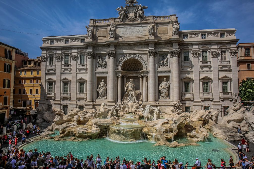 Rome Trevi Fountain with many tourists in front of it.