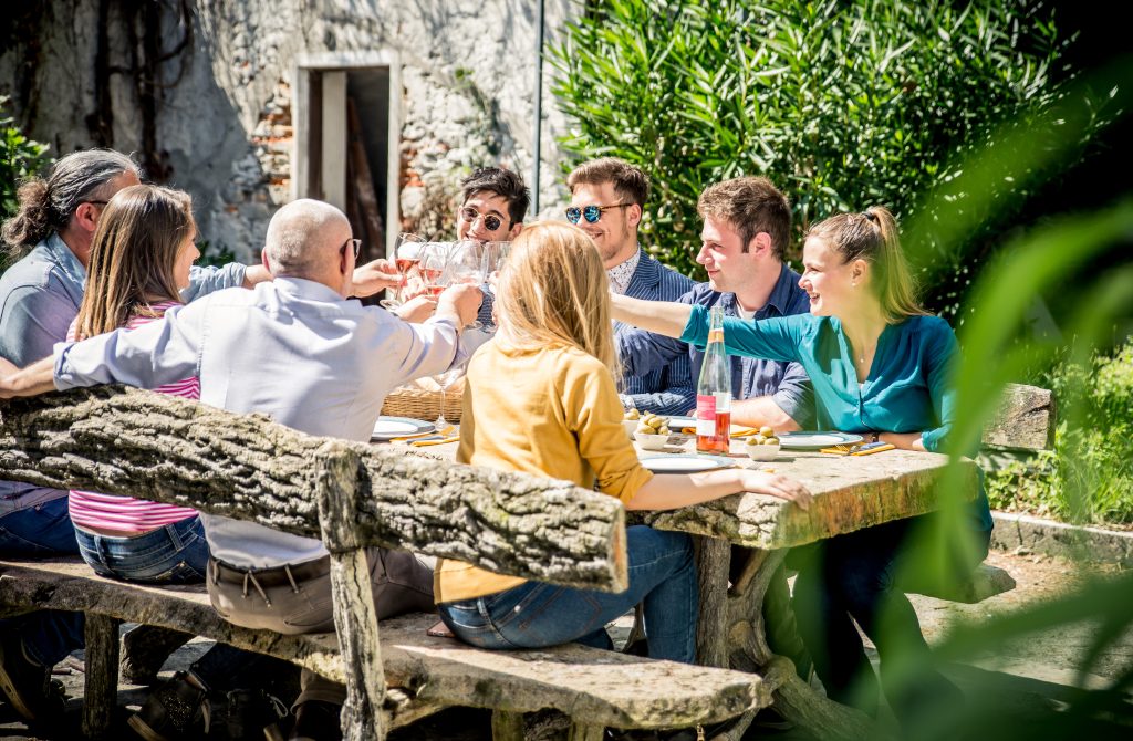 Group of people or team having lunch outdoors.