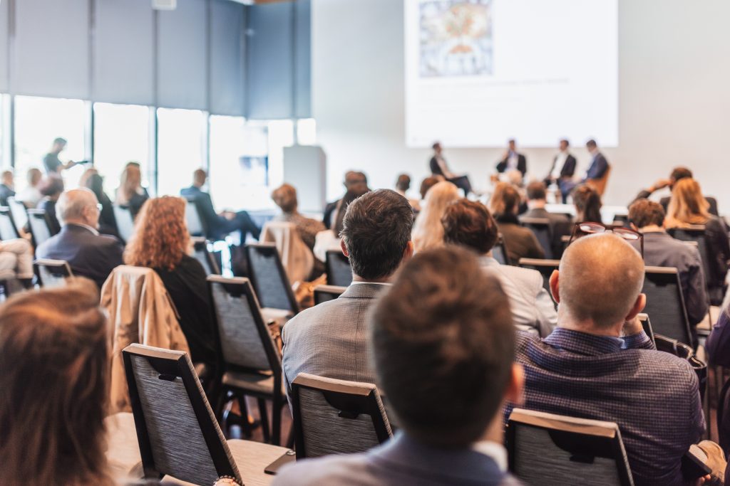 Group of people sitting in a meeting room at a conference.