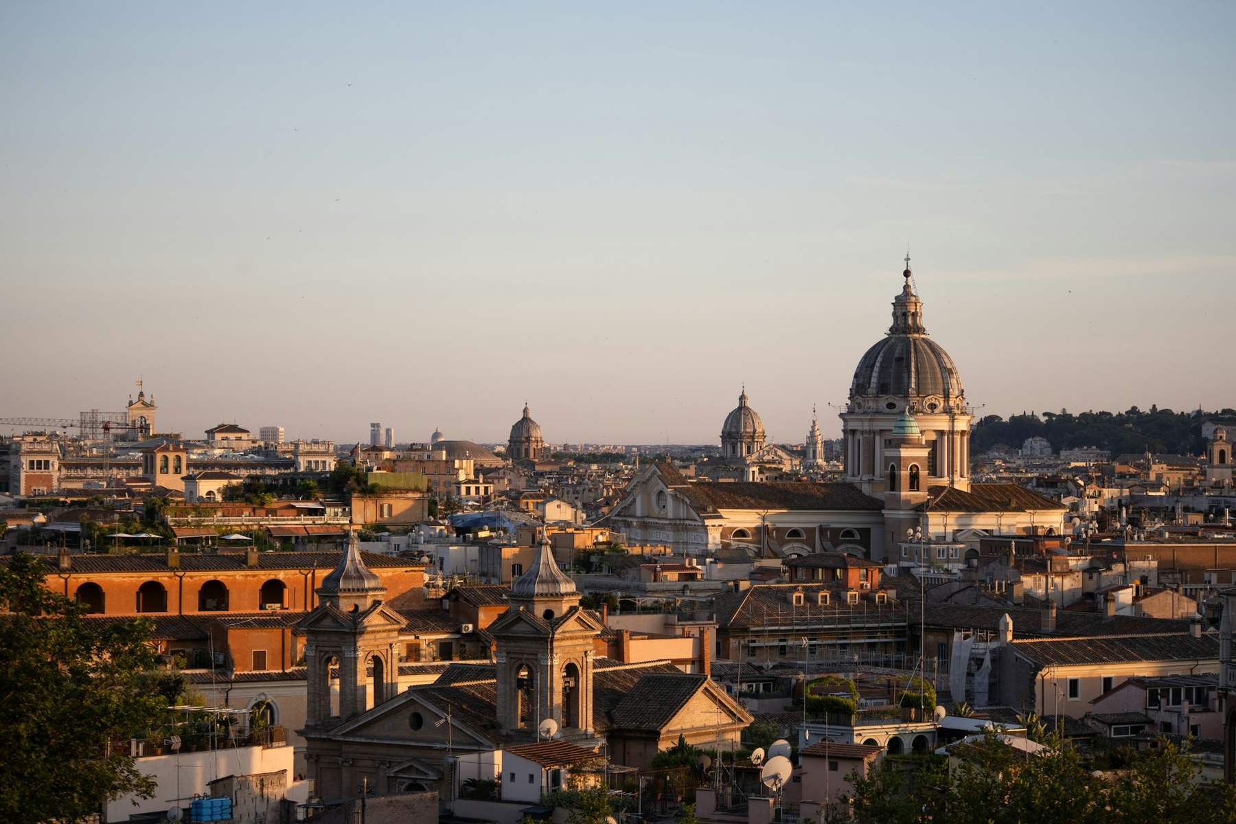 Rooftops, church domes and bell towers of central Rome in warm evening light